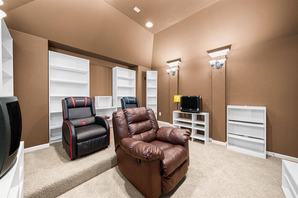 This dedicated entertainment space on the second floor features: Professionally designed dimmable lighting system. Custom built-in shelving for optimal storage and display. Thoughtfully positioned for privacy and immersive viewing. The room offers the perfect environment for movie nights or gaming, with its functional design and attention to acoustic considerations.