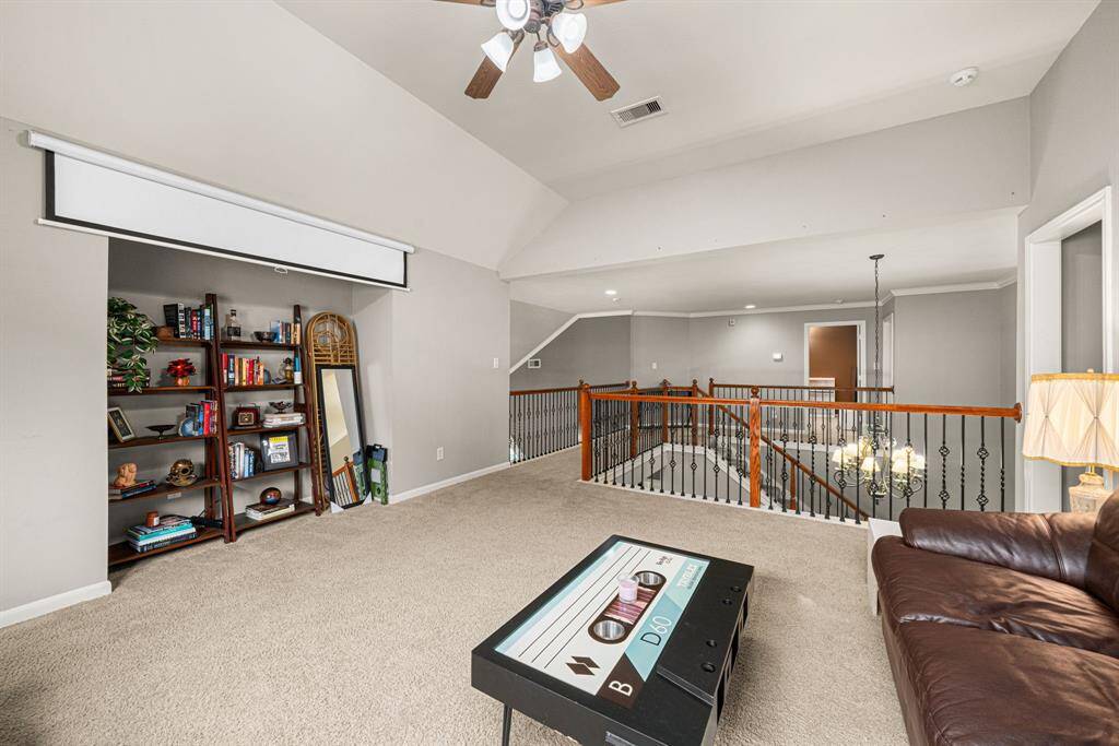Across to the media room, this expansive flex space with high ceilings offers multiple layout possibilities for gaming, recreation, or alternative use. The room features: A panoramic overlook to the level below. Ample natural light from well-placed windows. A spacious storage closet for organizational convenience