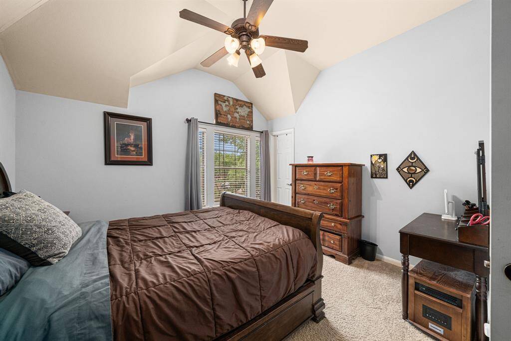 This generously proportioned bedroom features soaring ceilings that enhance the sense of space and airiness. The room includes an expansive walk-in closet with custom storage solutions, offering both functionality and refined style. Large windows bathe the space in natural light, creating a bright and welcoming retreat.