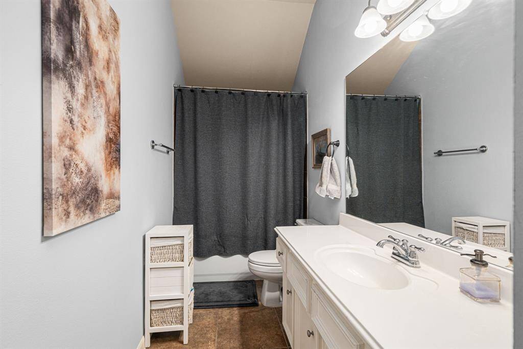 Conveniently situated between the third and fourth bedrooms on the second floor, this well-appointed bathroom features a versatile tub/shower combination and an expansive vanity with ample counter space. The functional layout and thoughtful placement provide comfortable access for both bedrooms.