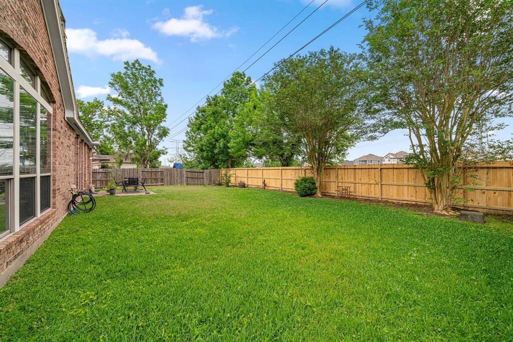 This expansive backyard offers exceptional privacy with no rear neighbors and features mature landscaping that provides natural beauty. The property includes an additional large side yard, perfect for outdoor entertaining or play