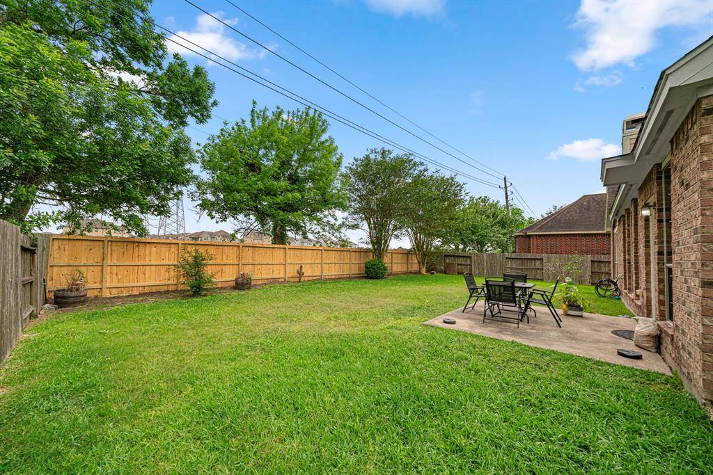 This expansive backyard offers exceptional privacy with no rear neighbors and features mature landscaping that provides natural beauty. The property includes an additional large side yard, perfect for outdoor entertaining or play