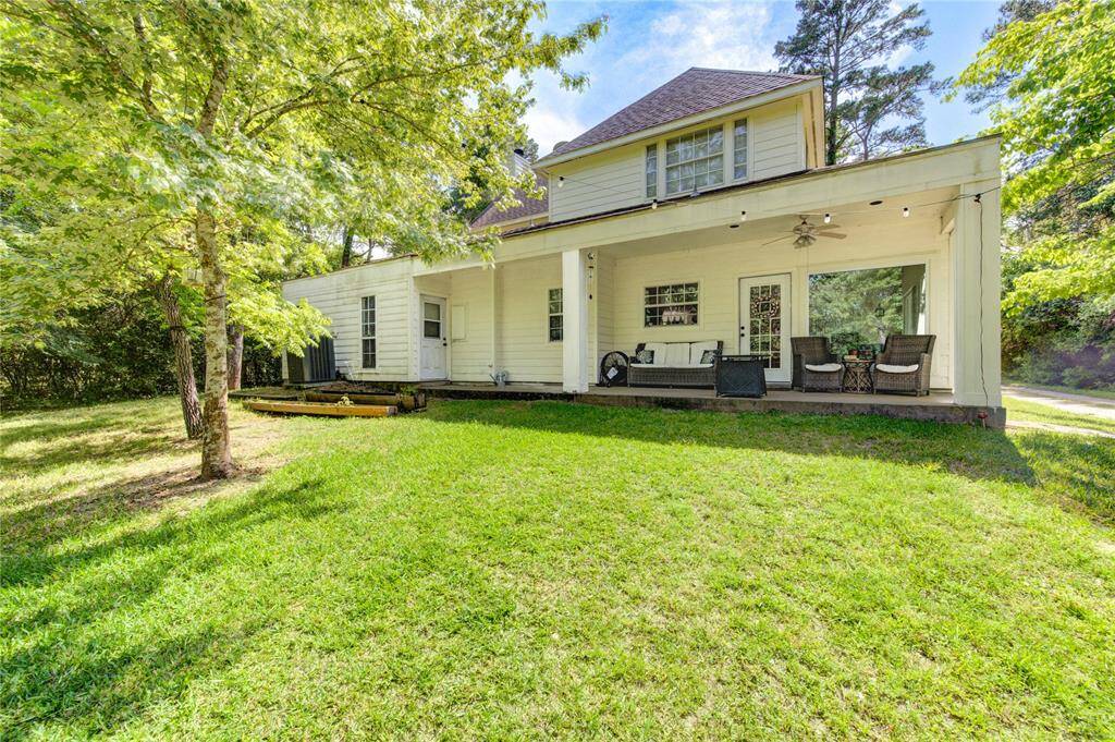 Charming two-story home with a spacious, covered patio perfect for outdoor relaxation. Surrounded by lush greenery, the backyard offers ample space for gardening or leisure activities. Ideal for those seeking a tranquil and inviting outdoor living area.