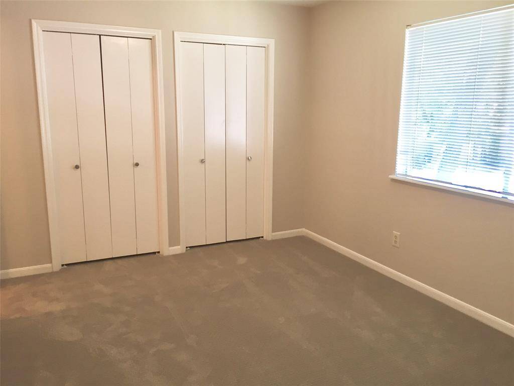 THIS IS an UPSTAIRS BEDROOM with two closets.  It has a nice window with a view of the community SWIMMING POOL and nice green park area.