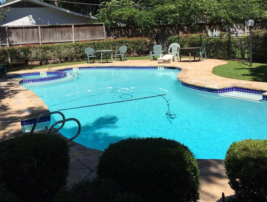 THIS is the COMMUNITY SWIMMING POOL with lounging furniture surrounded by nicely maintained green shrubbery and plants.  A great place to relax.
