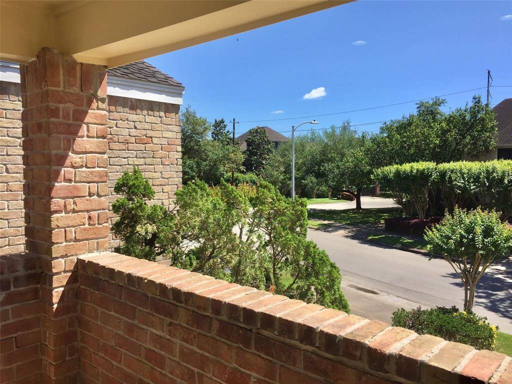 COVERED BRICK BALCONY is part of the Mastersuite.  It has an east view with nice trees and sky.