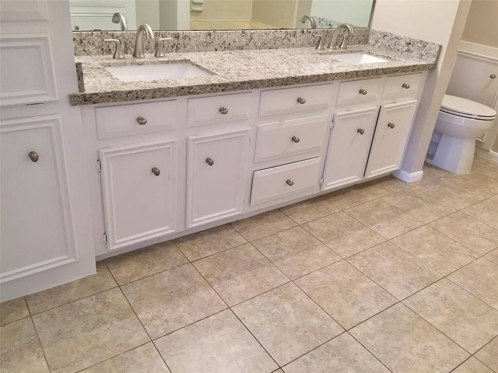 The PRIMARY BATH has been UPDATED with Granite countertops, tile flooring, and fresh paint.  It has DOUBLE VANITIES, laundry hamper, and lots of storage cabinets for towels etc.