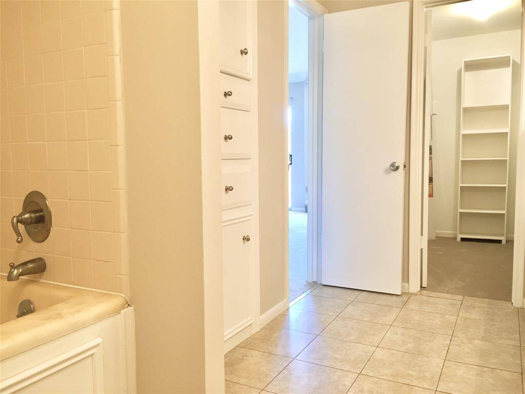 Here is ANOTHER VIEW of the PRIMARY BATH showing inset for tub/shower and entrance to the MASTER CLOSET.