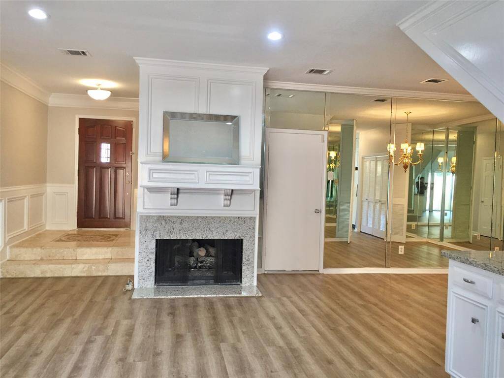 LIGHT AND BRIGHT open LIVING SPACES from Front Entry to Main Living area with Fireplace & Wetbar, and mirrored Dining Room.