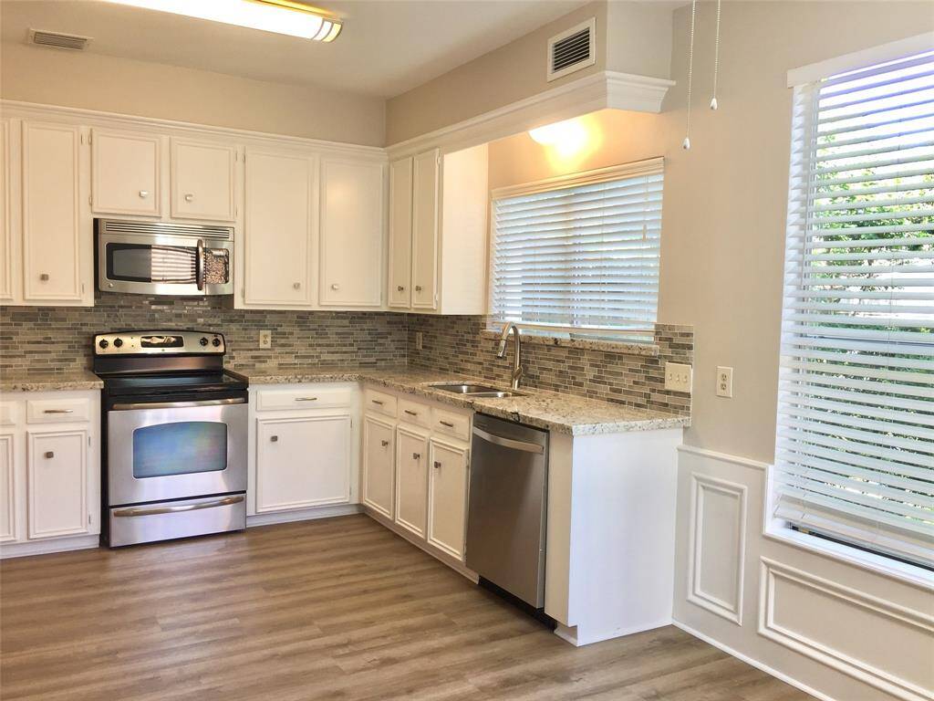UPDATED KITCHEN  - fresh paint, granite countertops, tile backsplash, and stainless appliances.