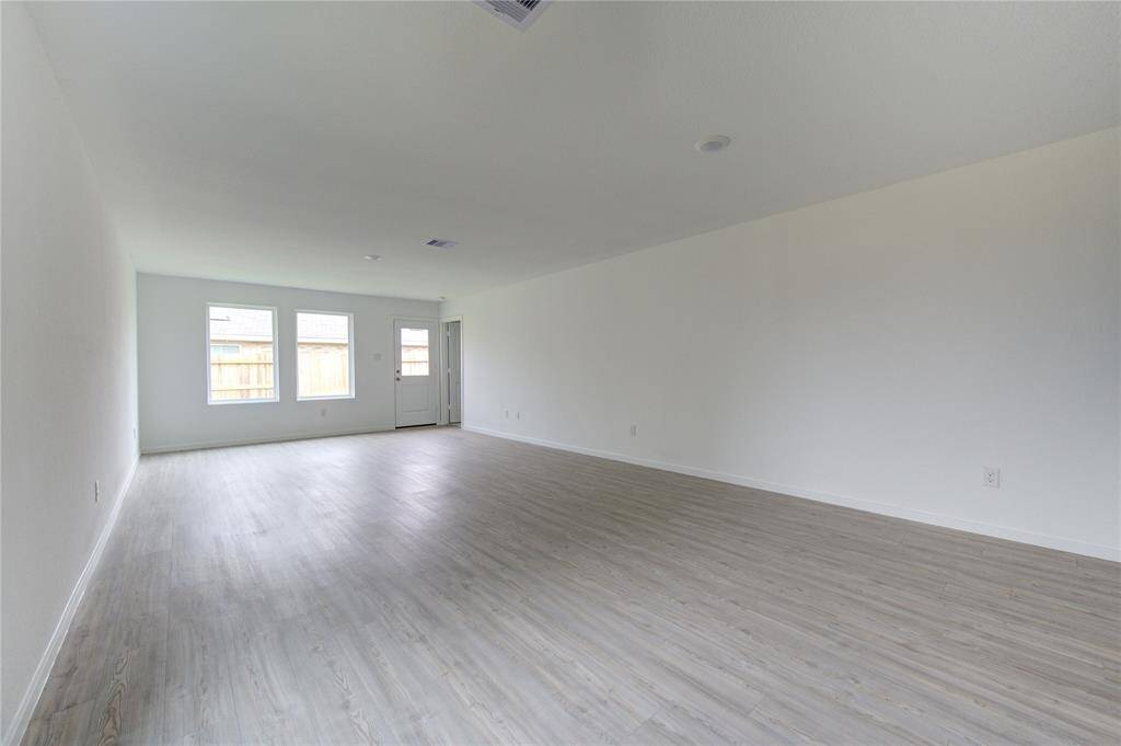 Light-colored wood or laminate with a subtle grain pattern
