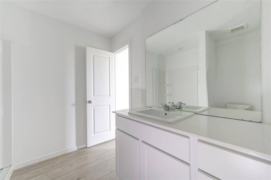 Sleek, white vanity with flat-panel cabinetry