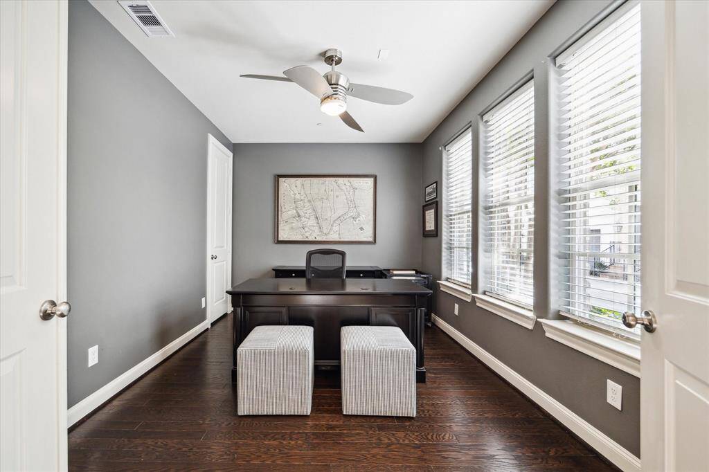 Inside the main-level suite, you’ll find handsome hardwood floors, a contemporary ceiling fan, a roomy walk-in closet and an en suite bathroom.