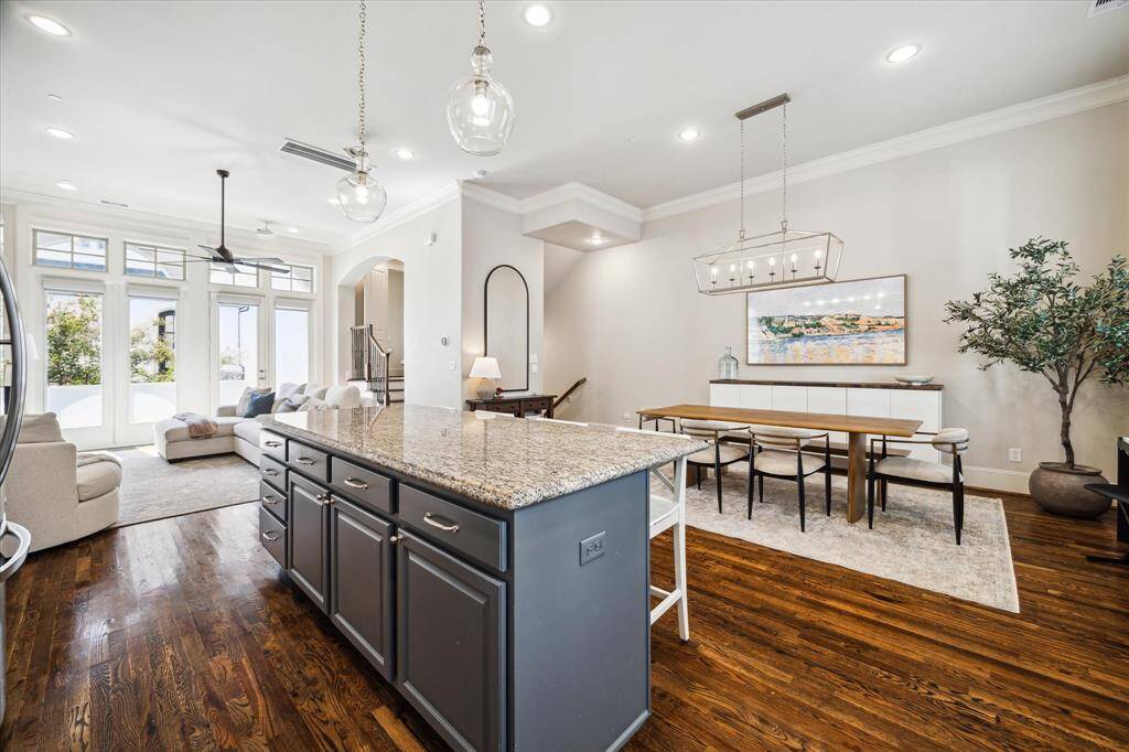 The wide breakfast bar/island adds storage and casual seating to the thoughtfully planned open kitchen.