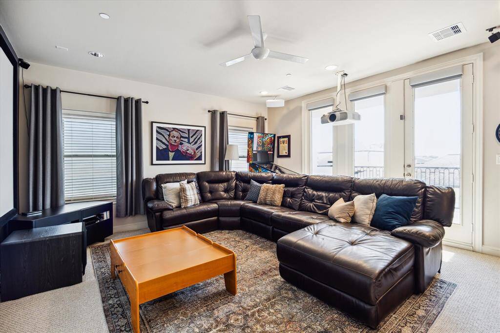 Featuring a walk-in closet, adjacent wet bar, and spacious roof deck, the expansive carpeted game room could easily serve as a media lounge, family room, playroom, fitness space or all of the above.