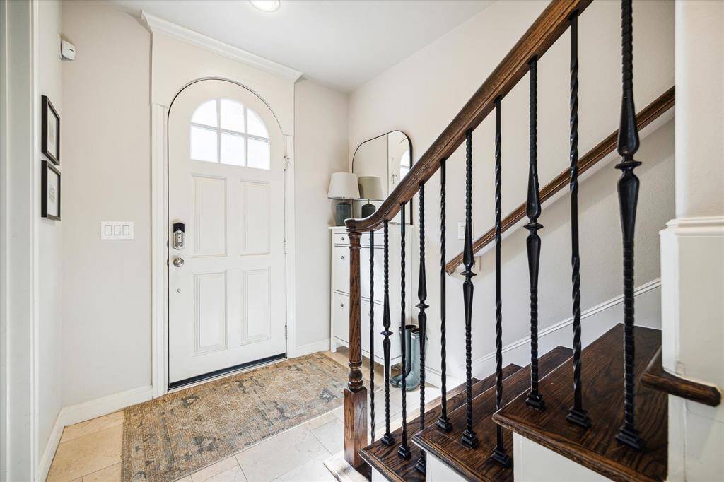 An arched door opens to the 2,970-square-foot home’s tiled first floor, where you’ll find a gracious foyer, access to the attached garage and a spacious secondary suite.