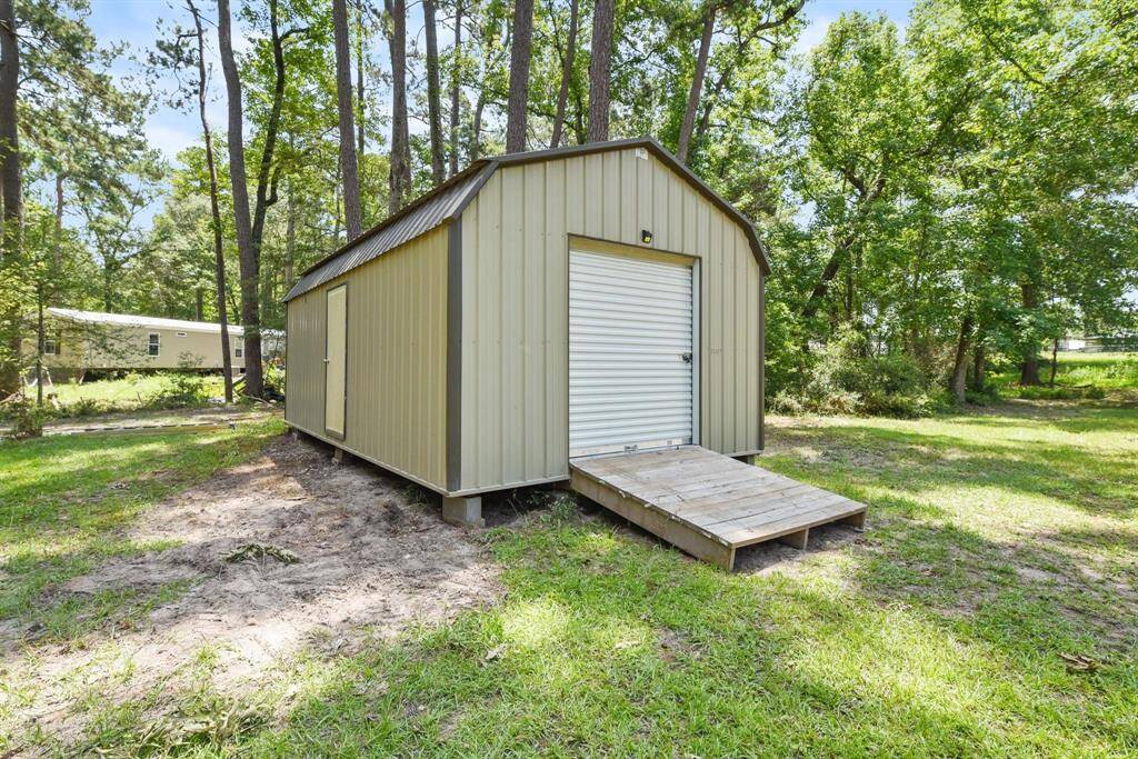 Large shed with roll up doors for easy storage.