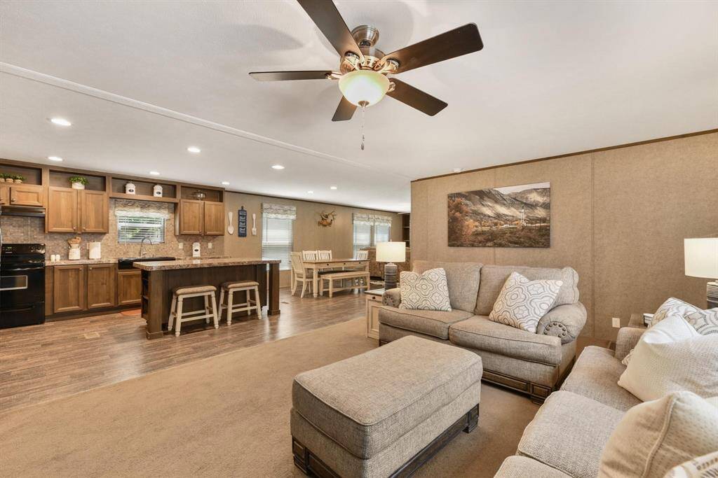 Another view of the kitchen with an island i this open concept home.