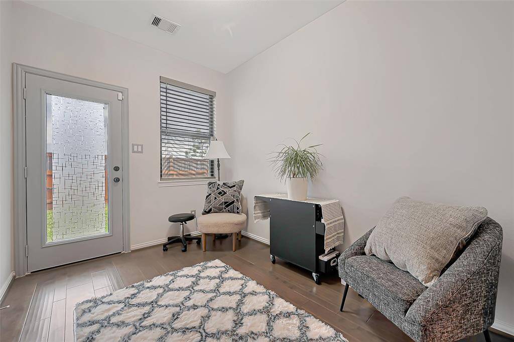 Cozy entryway space perfect for a small sitting area, reading nook, or flexible drop zone with backyard access.