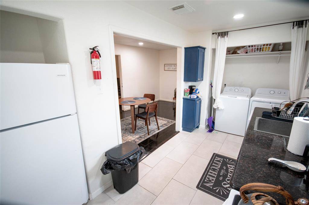 Another view of shared kitchen and washer & dryer area