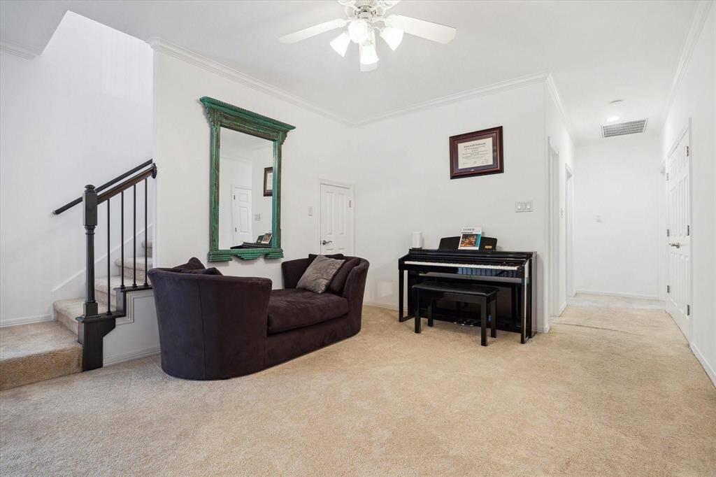 Spacious secondary bedroom with ceiling fan, ample natural light, and generous closet space—perfect for guests, teens, or a home office.