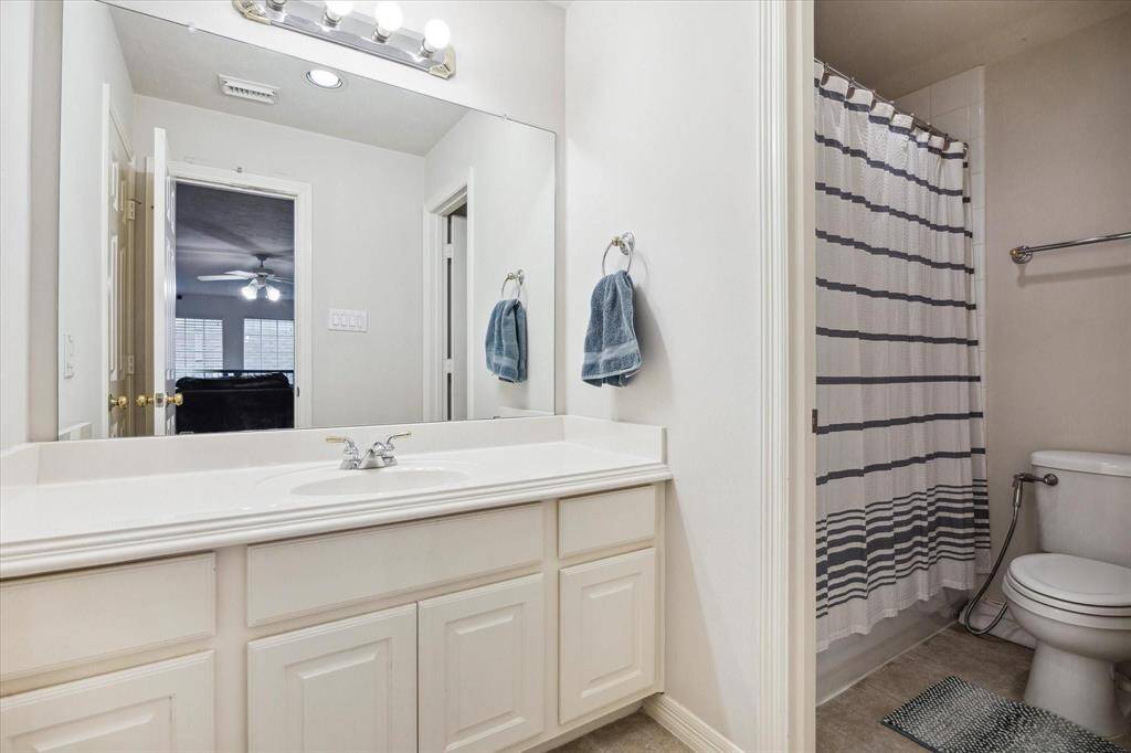 Charming and bright bedroom with large windows, neutral tones, and plenty of room for comfort and creativity.
