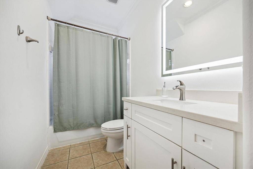 Well-equipped laundry room with built-in cabinetry, folding space, and full-size washer/dryer connections.