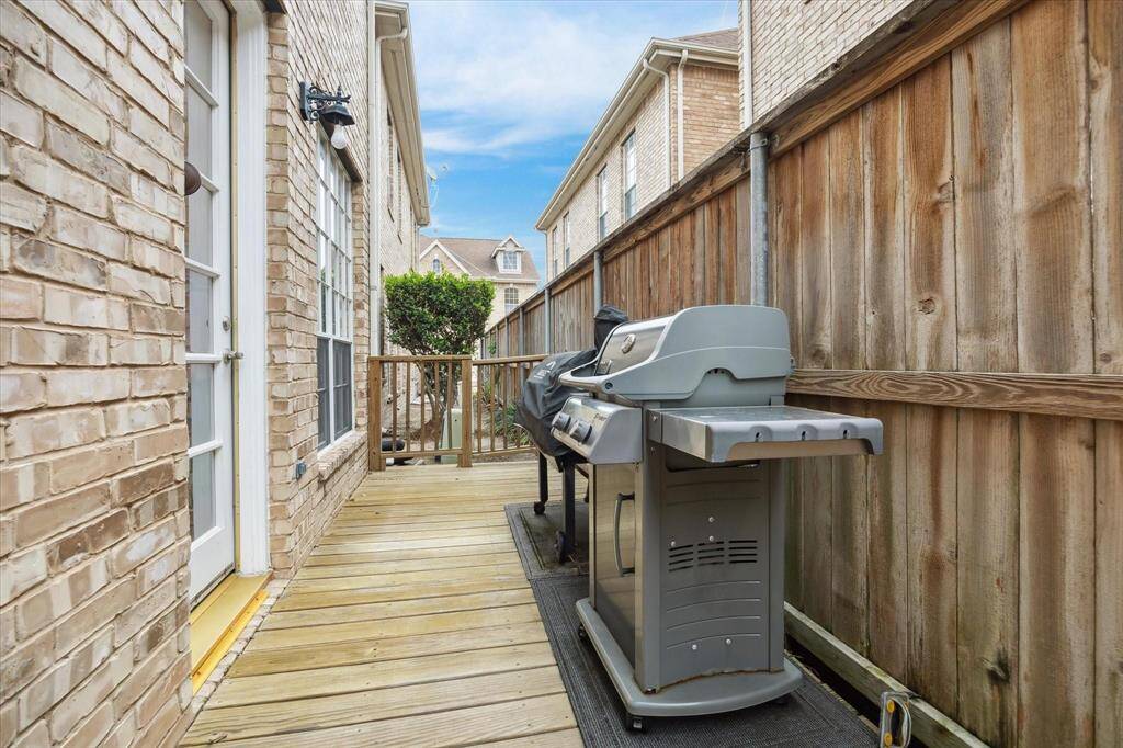Private side yard with wood decking, perfect for grilling and outdoor cooking—ideal for weekend BBQs or evening get-togethers.