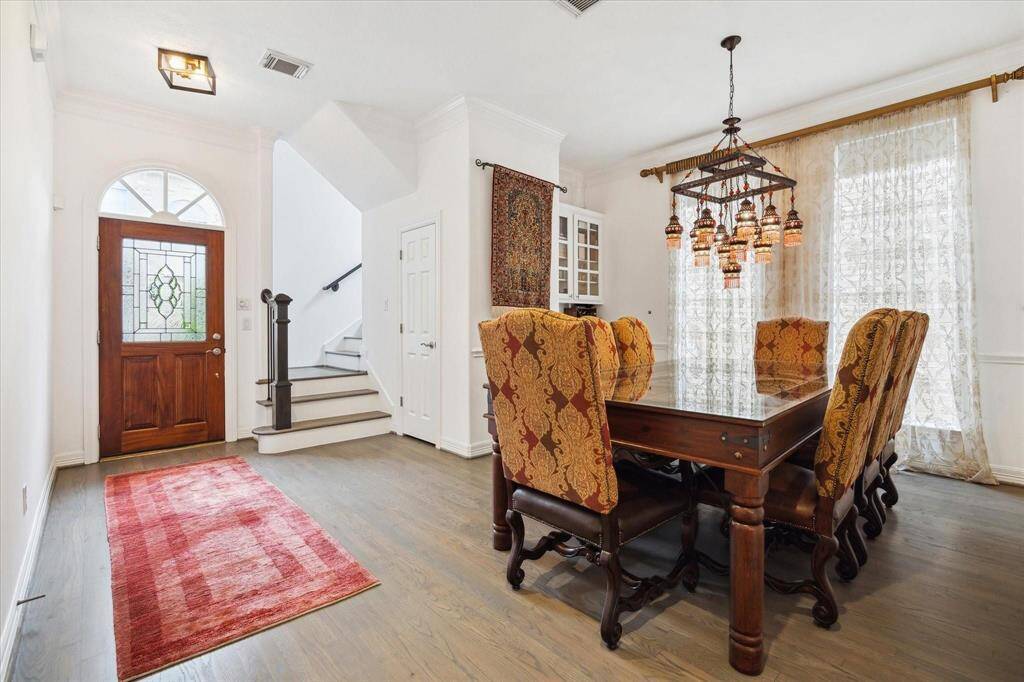 Elegant formal dining space with high ceilings, large windows, and plenty of room for entertaining in style.