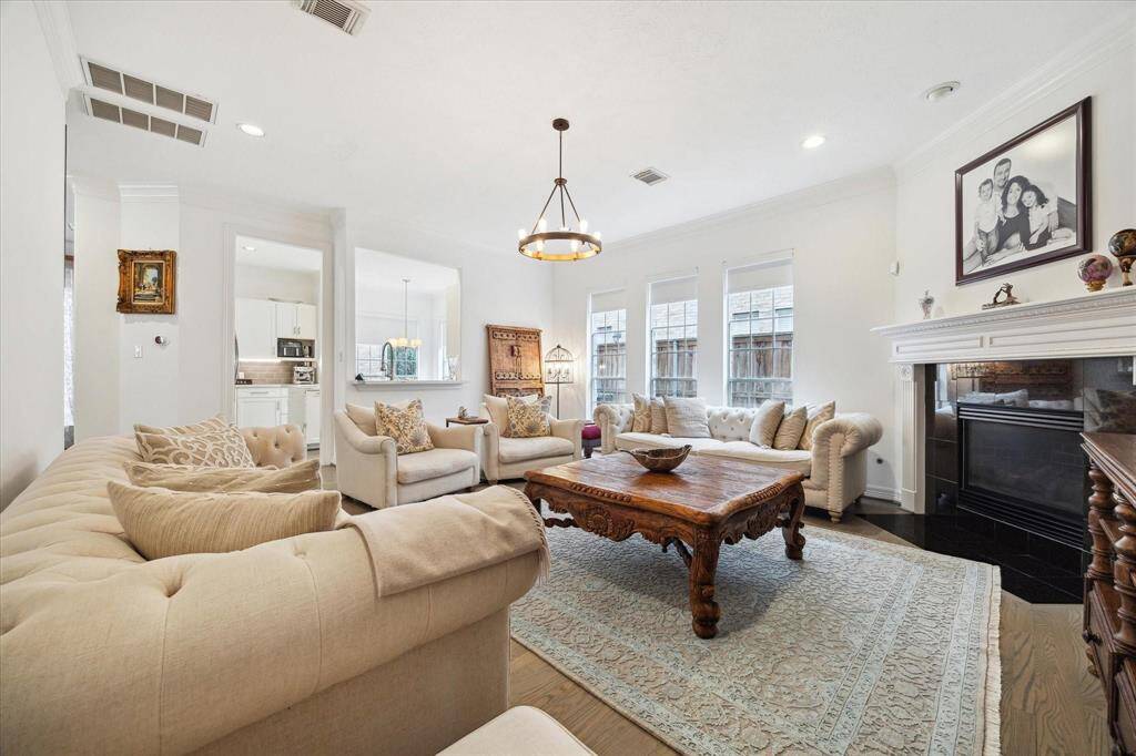 Another view of the inviting living area showcasing elegant finishes, natural light, and seamless flow into the kitchen and dining spaces.