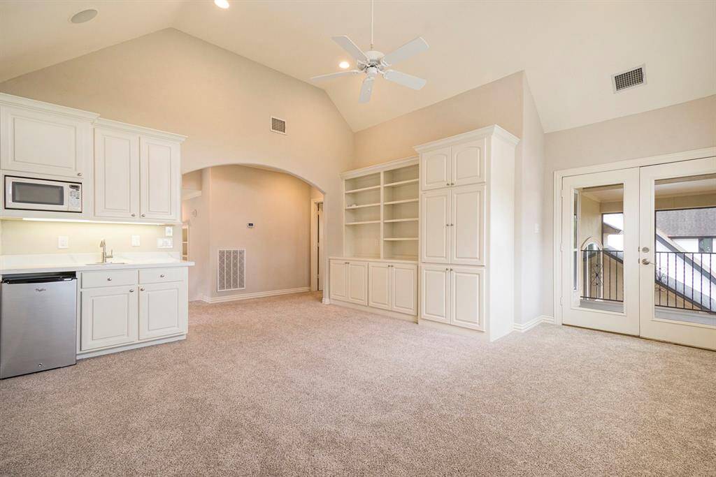 Wet bar area and cabinet storage in the game room