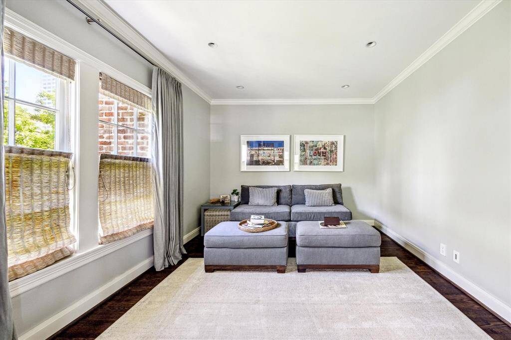 Just off the primary suite, this private sitting room offers a quiet escape with soft natural light, hardwood floors, and serene wall tones. Ideal for reading, lounging, or late-night unwinding, it adds flexibility and comfort to the owner's retreat.