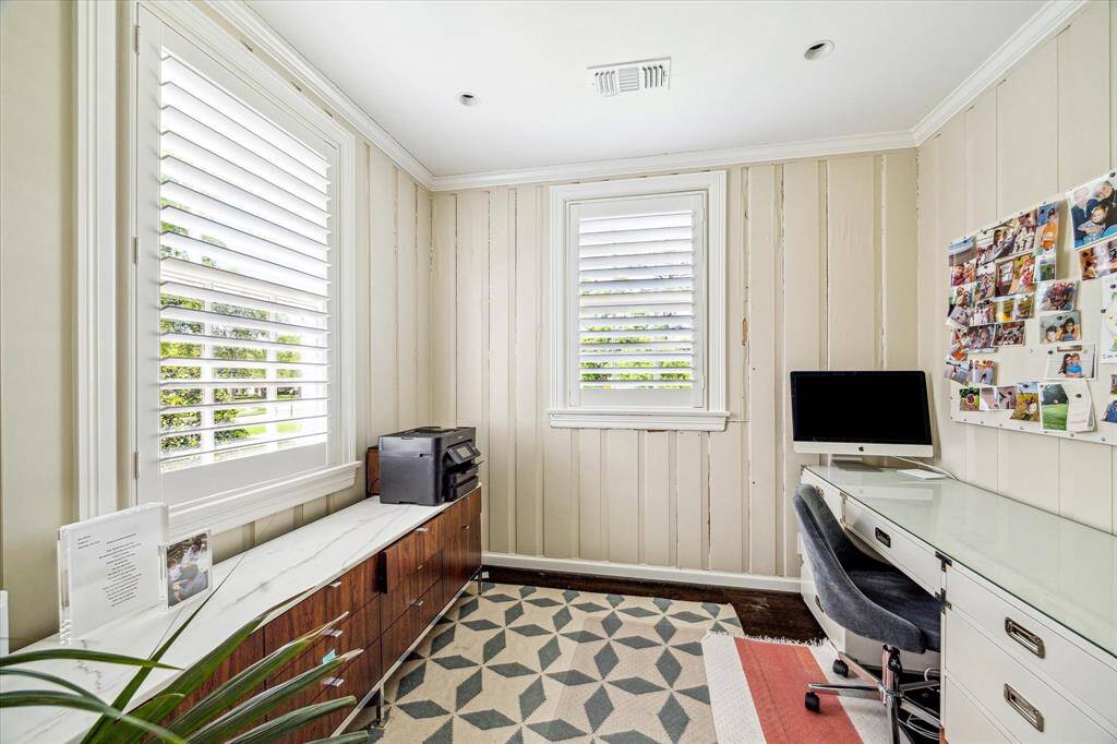 Tucked just off the upstairs landing, this cozy paneled study is filled with charm and natural light. With built-in storage, hardwood floors, and views of the front lawn, it’s the perfect nook for focused work or creative projects.