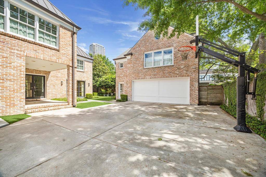 The backyard offers a perfect blend of function and relaxation with a covered porch for outdoor entertaining, a generous greenspace for play or gardening, and an oversized two-car garage topped with separate quarters—ideal for guests, a studio, or home office.