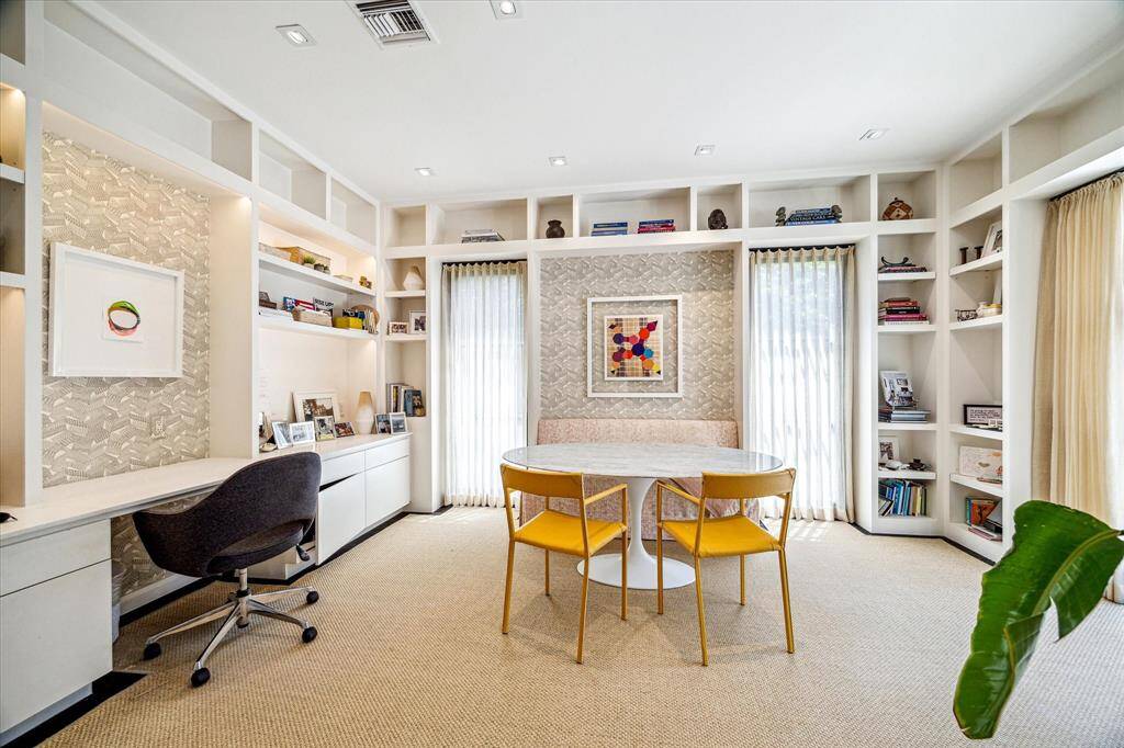 Designed with both style and productivity in mind, this home office/study features custom built-ins, a dedicated work station, and cozy banquette seating. Soft natural light filters through full-height drapery, creating a serene and inspiring workspace.