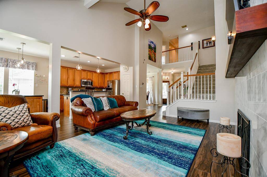 Even in a home of this size, you can create a cozy vibe, as suggested here in this amazing living/family space, with a heavenly high ceiling, complementing floor-to-ceiling fireplace and tons of natural light. Imagine this space filled with friends and family at holiday time, gathered 'round a glowing fire!