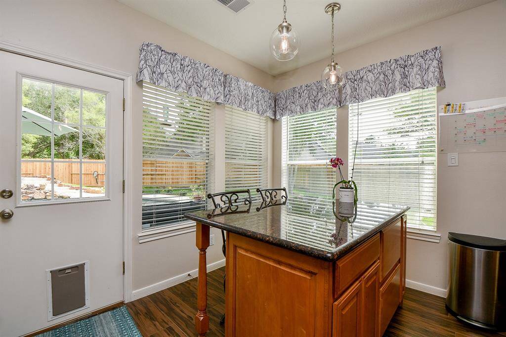 The breakfast/casual dining nook is straight ahead, surrounded by walls of windows.