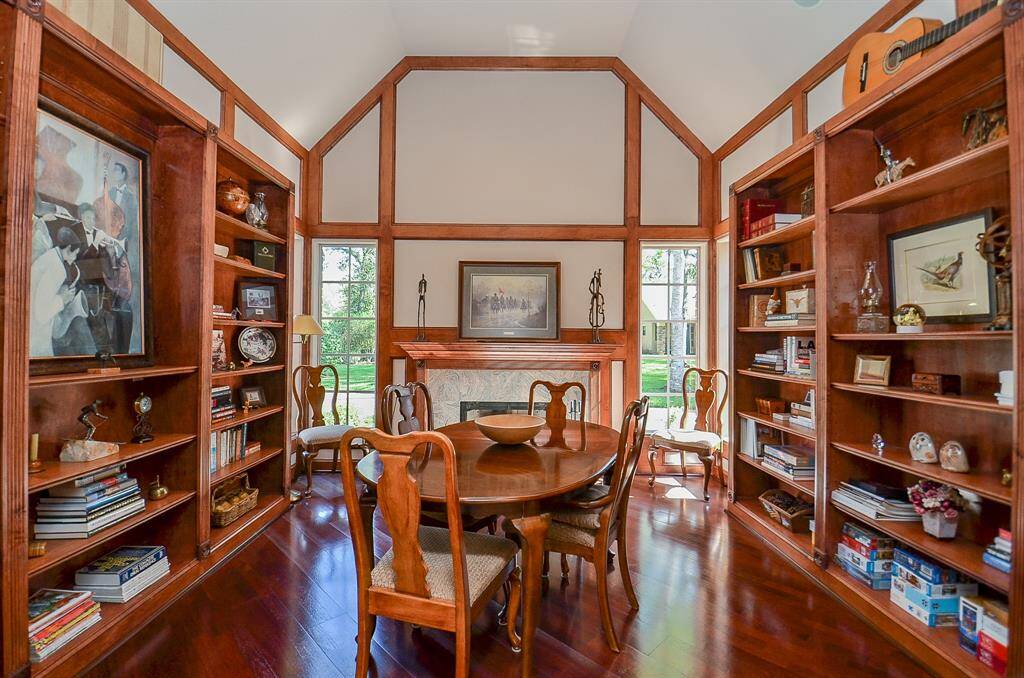 This Library is Grand!  Vaulted Ceiling, wood floors and an abundance of built in book shelves!