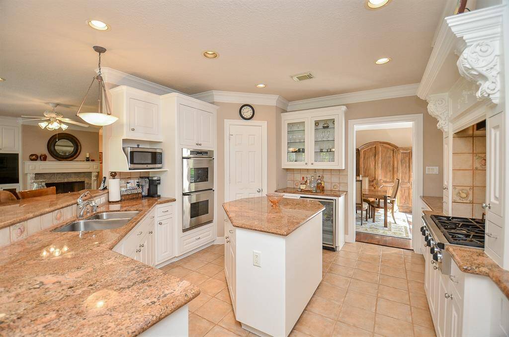 Large Island Kitchen with Granite Counters and a huge wrap around bar that offers additional seating!