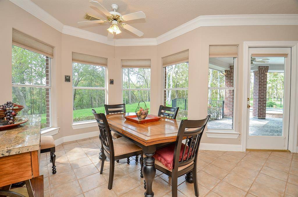 Large Breakfast Room surrounded by windows showing off the beautiful backyard.