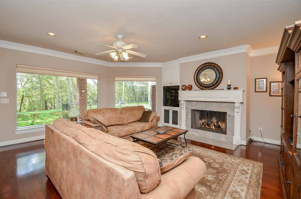 This Family Room has a fireplace, built-in cabinets and wood floors!