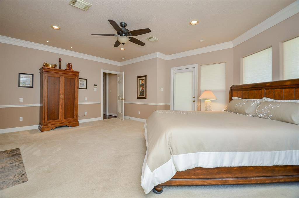 Another View of the beautiful Primary Bedroom with its crown molding and numerous windows that allow for a lot of natural light!