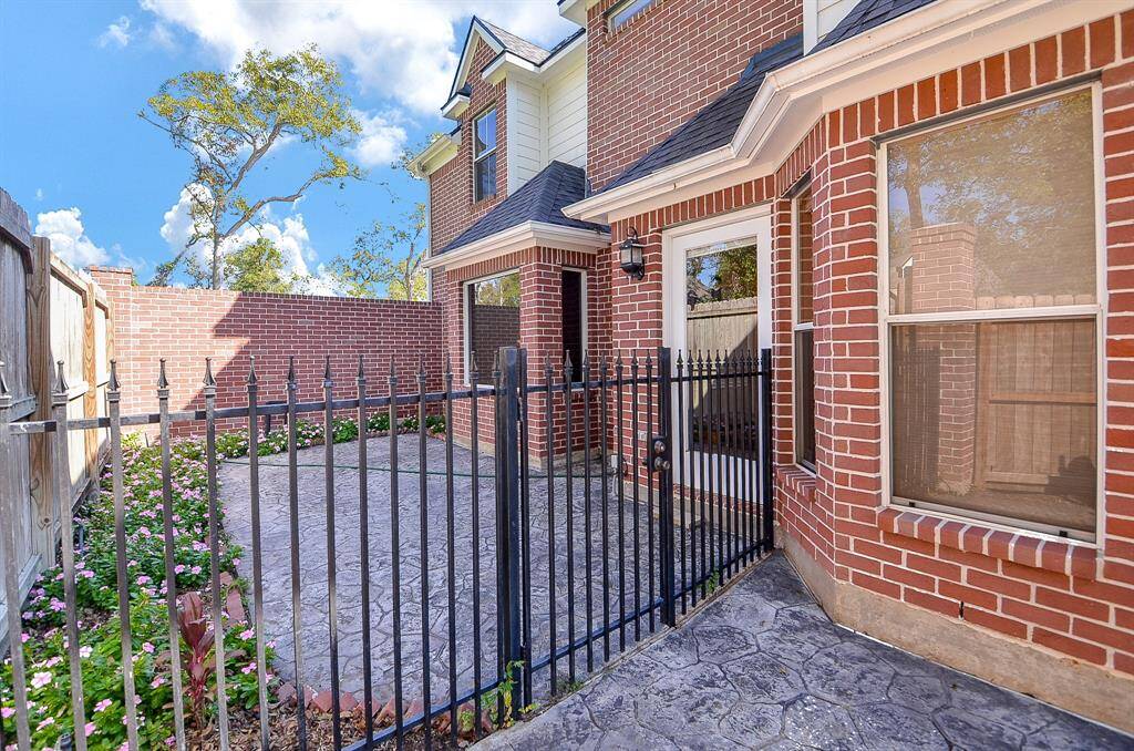 A private patio area off the Primary Bedroom that is cozy and landscaped with amazing flowers!