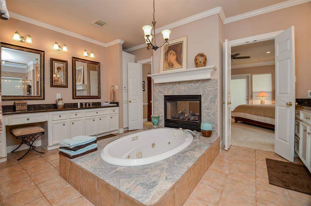 A huge Primary Bathroom with a jetted tub, a fireplace and separate vanity areas!