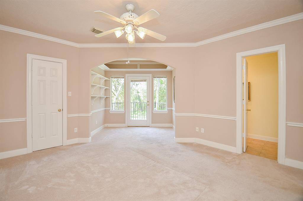 One of the secondary bedrooms upstairs!  This one has a sitting area plus a balcony!   All secondary bedrooms have walk in closets!