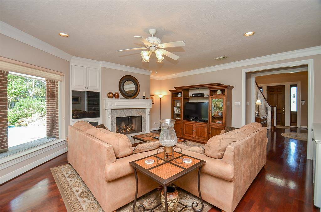 Family Room boasts wood floors, a fireplace, built in cabinets/shelves and amazing views of backyard paradise!