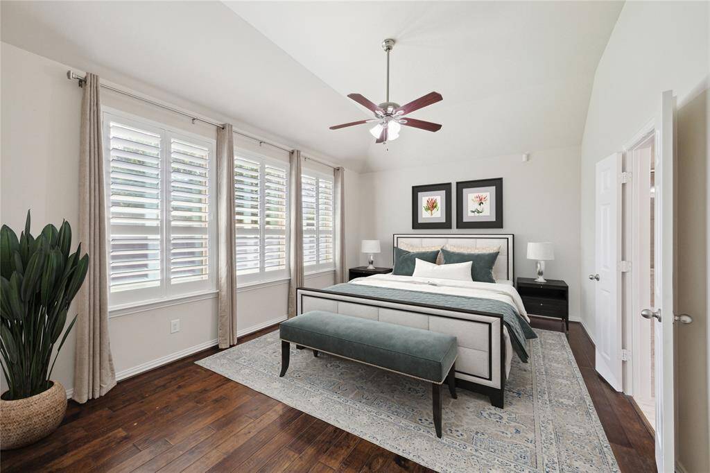 First floor Primary Bedroom (18x13). Hardwood flooring, decorative window coverings and ceiling fan. High quality plantation shutters, high ceilings all overlook large backyard. Virtually staged.
