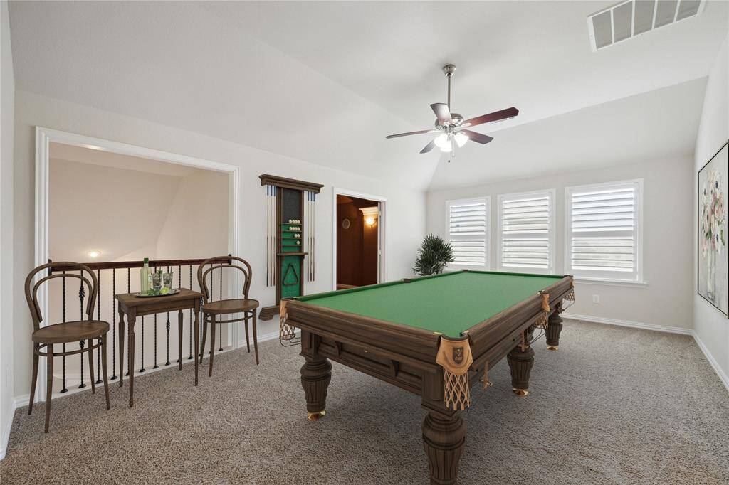 On second level open Gameroom (19x13) with carpet, entire second level very lightly lived in!Wall of windows with plantation shutters, coffered ceiling, and glimpse of fun media room space. Virtually staged.