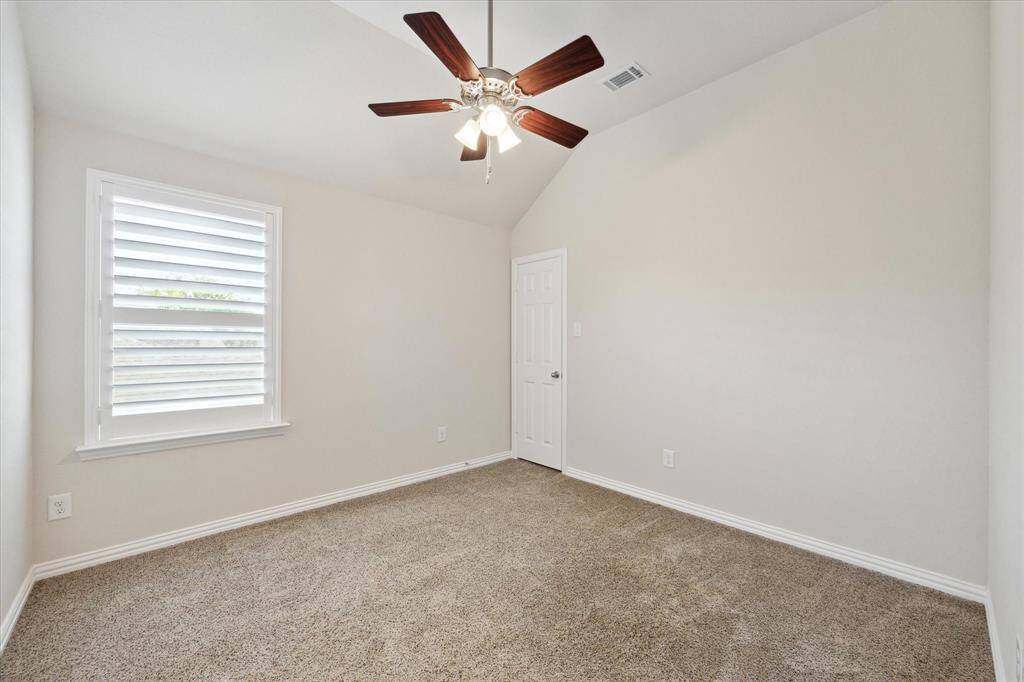 One of two Secondary bedrooms on second level. This one is approximately (11x11). Carpet, neutral paint colors, high ceilings, and plantation shutters.