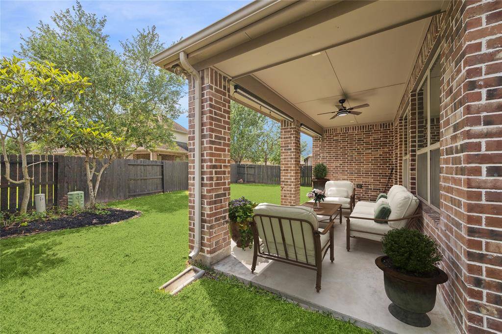 Nice sized backyard, lot is 7,762 per Brazoria County Appraisal District. Covered patio provides nice shade with ceiling fan. Plenty of green lawn space for pets and play. Virtually staged.